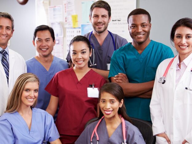 Portrait-Of-Medical-Team-At-Nurses-Station-465592927_1255x837-e1593159562989 (1)